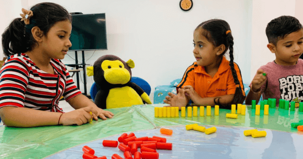 eacher guiding kids through early math activities at a pre-school in Gurgaon